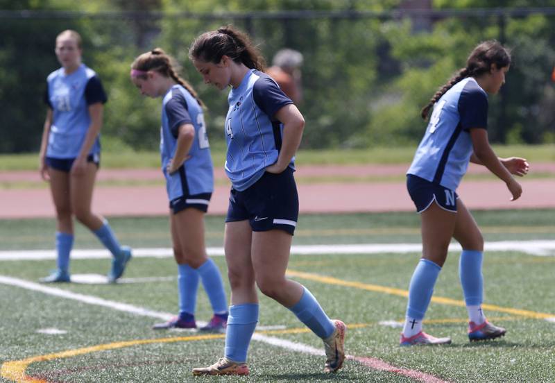 Nazareth Academy's Izzy Strnic and here teammates react to St. Ignatius College Prep scoring in the final minute to win their  IHSA Class 2A State Girls Soccer semifinal match on Friday, June 6, 2025, at North Central College in Naperville.