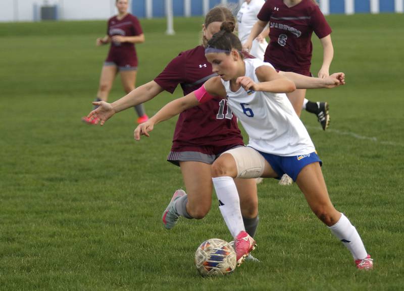 Johnsburg’s Liz Smith controls the ball  against Marengo's Mackenzie Westwood during a Kishwaukee River Conference soccer match on Wednesday, April 15, 2026, at Marengo High School.