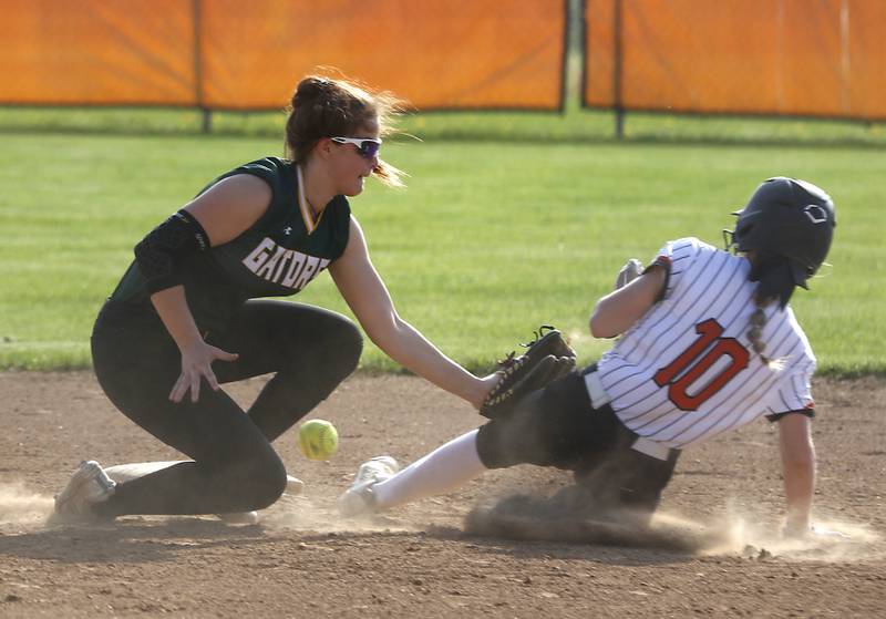 Crystal Lake South's Stephanie Lesniewski looses the ball as she tries to tag out McHenry’s Tatum Kornfeind during a Fox Valley Conference softball game Monday, May 9, 2022, between McHenry and Crystal Lake South at McHenry High School.