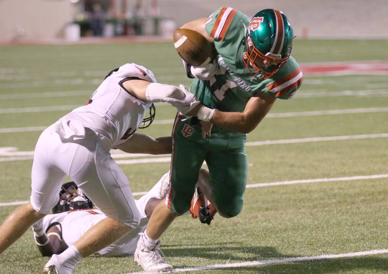 L-P's Josh Senica carries the football past a Metamora defender on Friday, Sept. 1, 2023 at Howard Fellows Stadium.