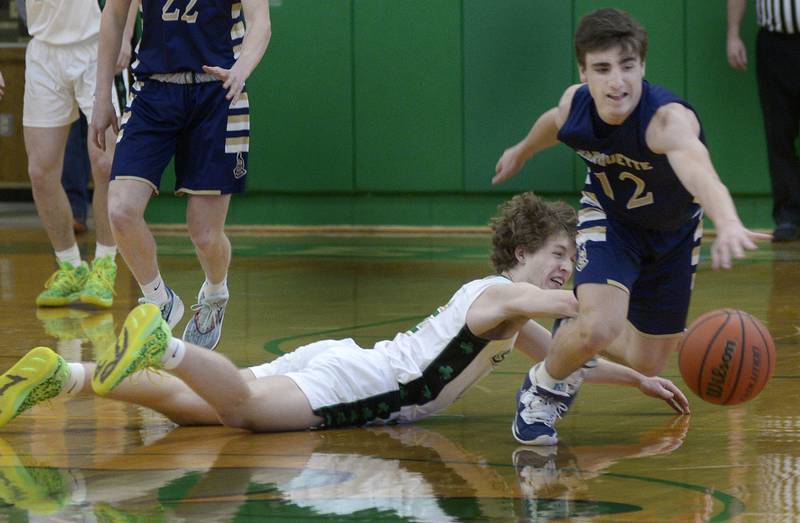 Marquette’s Denver Trainor and Seneca’s Kenny Daggett chase after a loose ball Tuesday during the 2nd period at Seneca.