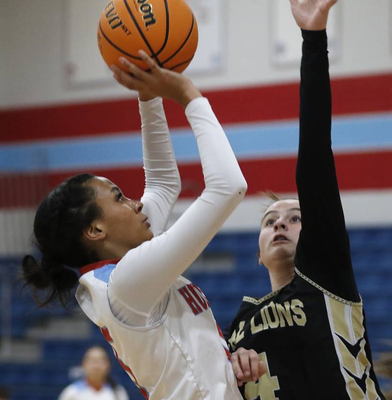 Marian Central's Kalia Parris drives to the basket against Rockford Christian's Teagan Lawver during a nononference basketball game on Monday, Feb. 10, 2025, at Marian Central High School  in Woodstock.