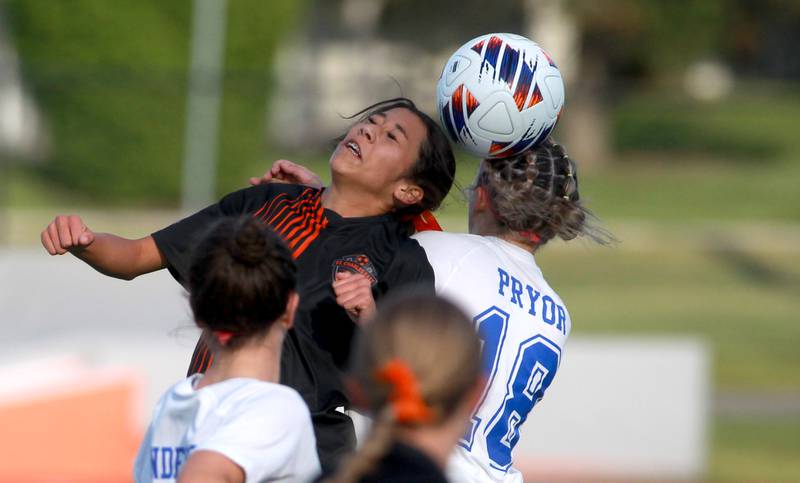 St. Charles East's Mya Leon and Geneva's Riley Pryor head the ball during the Class 3A St. Charles East Regional final on Friday, May 23, 2025 in St. Charles.