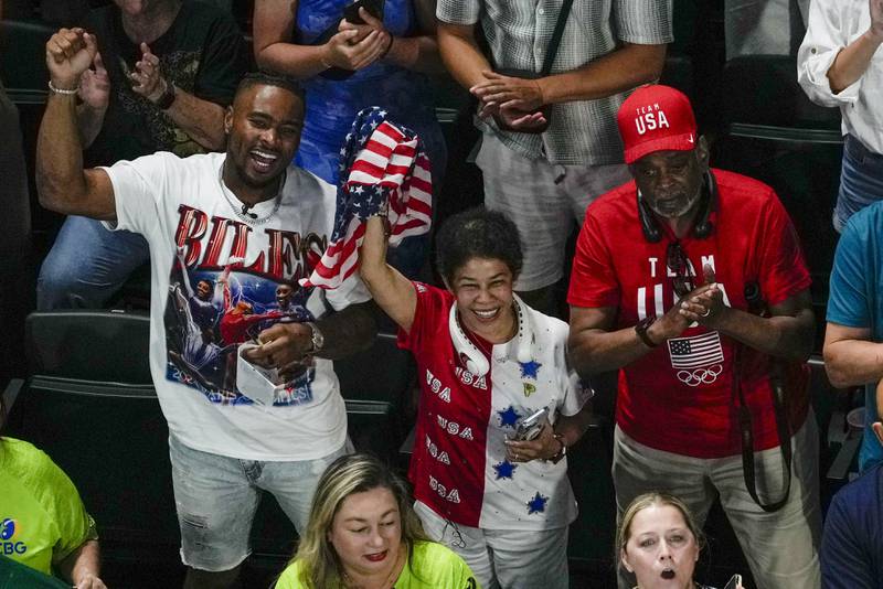 CORRECTS OWENS FIRST NAME U.S. gymnast Simone Biles' husband Jonathan Owens, left, with her parents Ron and Nellie Biles, cheer after the women's artistic gymnastics team finals at the 2024 Summer Olympics, Tuesday, July 30, 2024, in Paris, France. (AP Photo/Morry Gash)