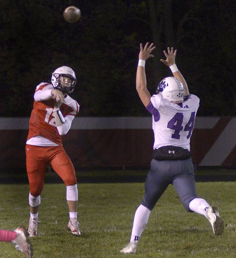 Streator Quarterback Christian Benning gets a pass of as Wilmington’s Brendan Moran rushes in during 1st quarter Friday at Streator.