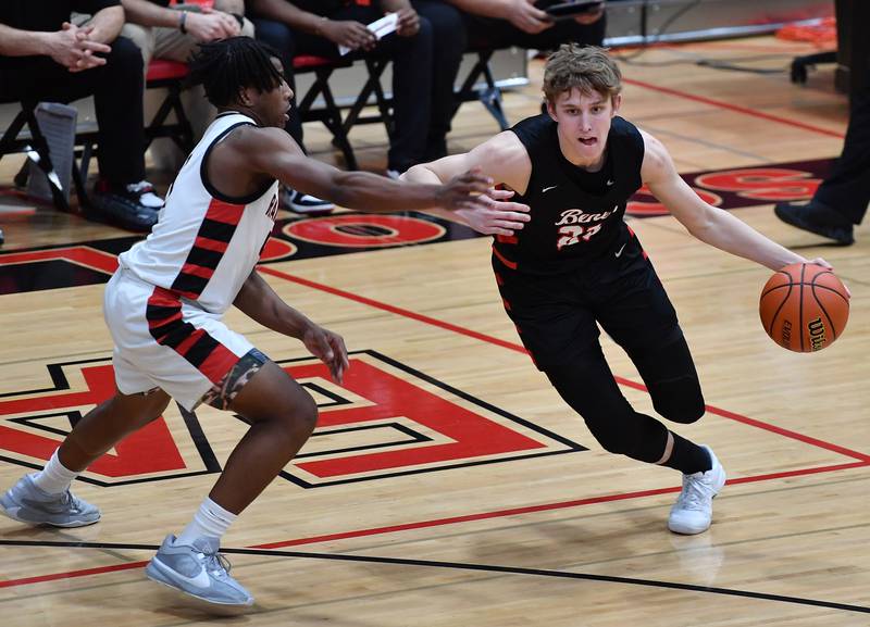 Benet's Gabe Sularski (25) drives as Bolingbrook's Kevin Cathey defends during a Class 4A East Aurora Sectional semifinal game on Feb. 27, 2024 at East Aurora High School in Aurora.