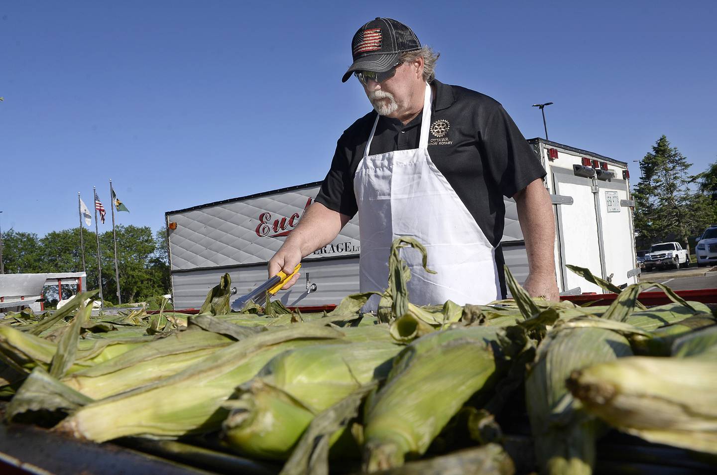 The Noon Rotary Club’s Craig Emmett grills ears of corn for Wine Fest attendees to enjoy with their wine Friday, June 3, 2022, during opening night of the festival in downtown Ottawa. The event runs through Sunday.