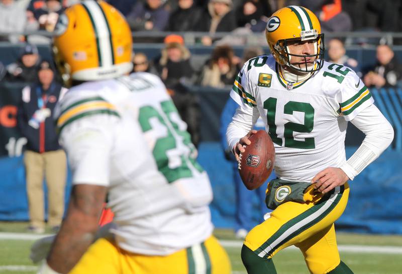 Green Bay Packers quarterback Aaron Rodgers scrambles away from the Chicago Bears pass rush during their game Sunday, Dec. 4, 2022, at Soldier Field in Chicago.