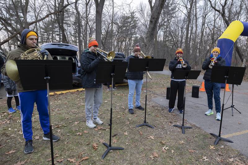 A symphonic brass quintet from Boston plays the national anthem Thursday, Nov. 28, 2024, for St. Anne’s Turkey Trot 5K. The group's members are friends of local musician Maxwell DeForest.