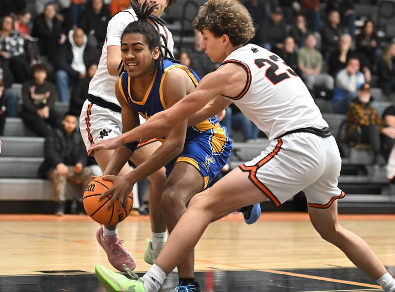 Joliet Central's Malachi Kinzie (32) looks to make a play during a conference game against Minooka on Friday, Jan. 10, 2025, at Minooka.