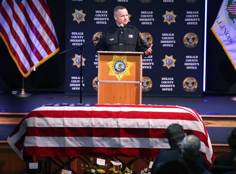 Current DeKalb County Sheriff Andy Sullivan speaks over the casket of former DeKalb County Sheriff Roger Scott during his memorial service Friday, March 7, 2025, at Bethany Road Bible Church in DeKalb. Scott, who was the county sheriff for 36 years, died on February 23 at the age of 78.
