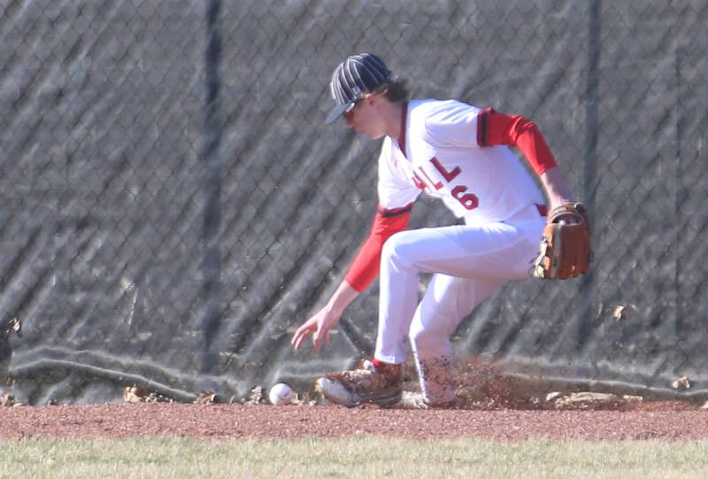 Hall's Hunter Edgcomb picks up the ball at the warning track as it soars over his head and off the wall on Monday, March 17, 2025 at Putnam County High School.