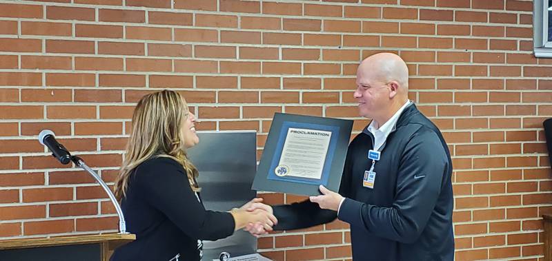 Mary Oros, a member of the Dixon City Council, presents Dave Schreiner, chief executive officer of KSB Hospital, with a proclamation observing KSB's 125th anniversary on Saturday.