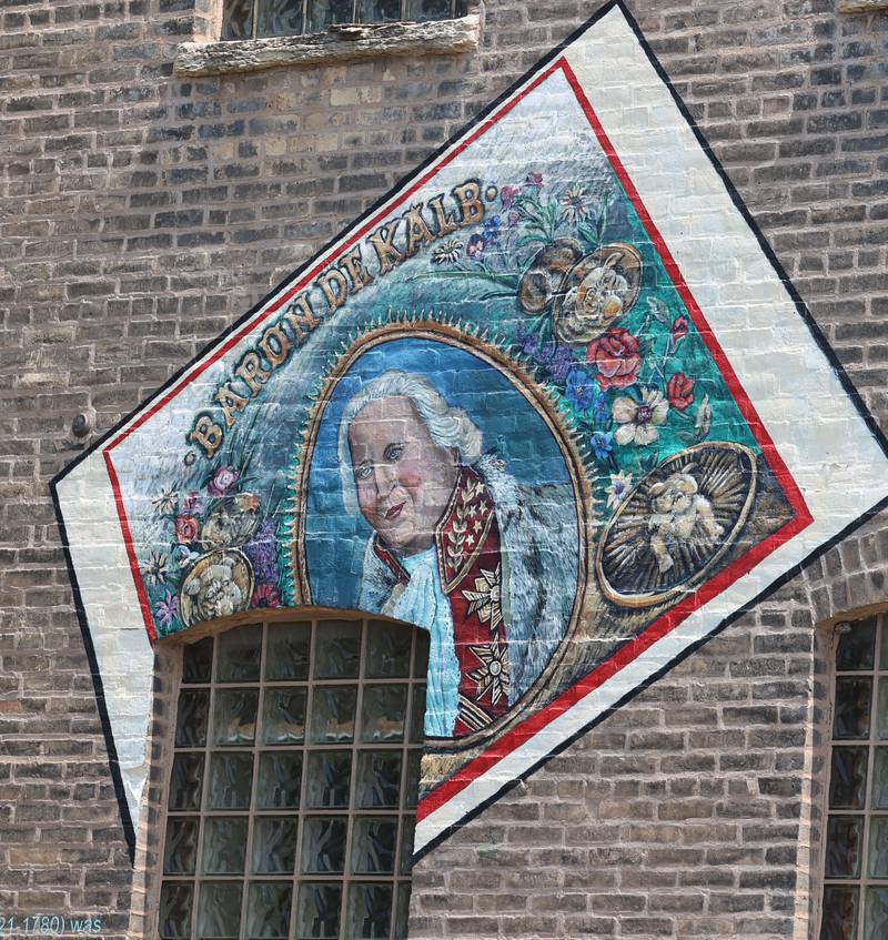 A detail of the mural titled “Its Merits Recommend It...” by artist Olivia Gude Tuesday, July 22, 2025. The artwork graces the side of the building at the corner of Lincoln Highway and First Street in DeKalb.