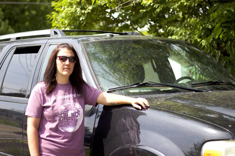 Danielle Duhoski, of New Lenox, standing next to her 2012 Ford Expedition on June 15, 2025, outside her residence.