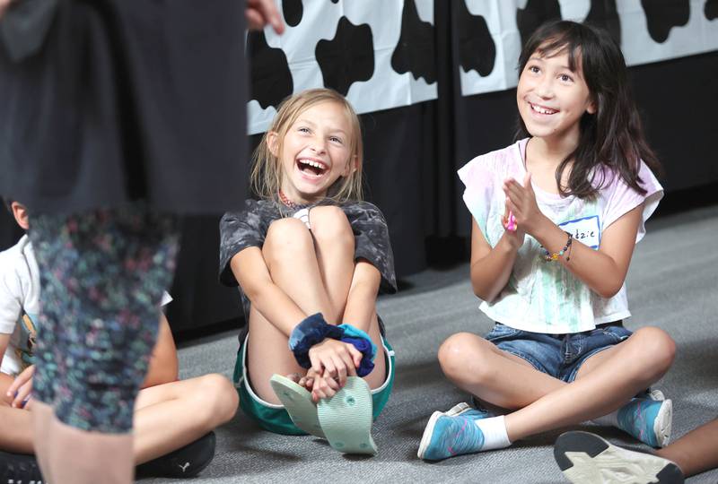 Keera Bengford-Breneisen (left) 9, from DeKalb and Kedzie Kaiser, 9, laugh as volunteer makes a joke Monday, July 11, 2022, during of a session of Summer Reading Vacation put on by Neighbors' House in DeKalb in conjunction with the DeKalb County Farm Bureau. Christ Community Church is hosting the camp this week in their outreach center on North 6th Street in DeKalb.