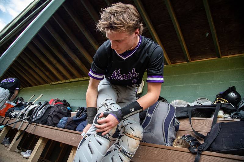 Downer’s Grove North catcher Jack Romsey equips himself for the next inning during a game against Lyons Township in Downers Grove on Monday, May 12, 2025.
