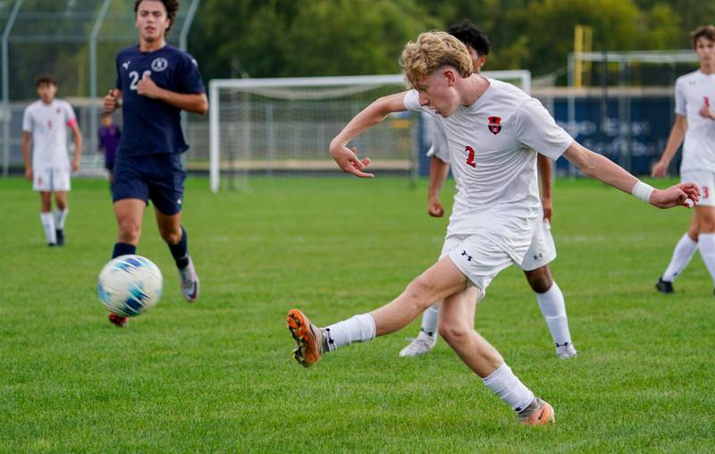 Oswego’s Alan Mindock (2) shoots the ball against Oswego East during a soccer match at Oswego East High School on Tuesday, Sept. 26, 2023.