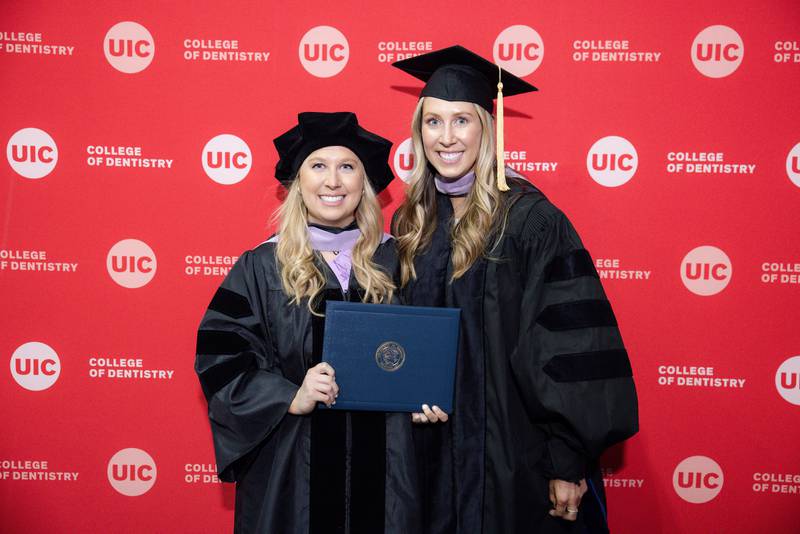 Chelsea Schultz, 27, of Gardner (left) is seen with her sister Kailyn Schultz (right_ when Chelsea graduated from the University of Illinois Chicago College of Dentistry on Thursday, May 5, 2022. Kailyn is also a dentist.
