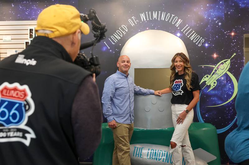 Wilmington Mayor Ben Dietz and his wife, Jessica, right, pose with the new Gemini Giant photo op wall inside The Landing Pad Souvenir Shop's grand opening at Wilmington's South Island Park on Thursday, May 22, 2025.
