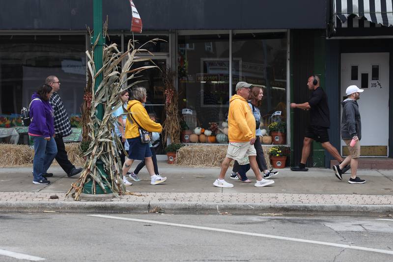 A group walks down Liberty Street which is decorated for the 75th Annual Grundy County Corn Festival on Saturday, Sept. 28, 2024 in downtown Morris.