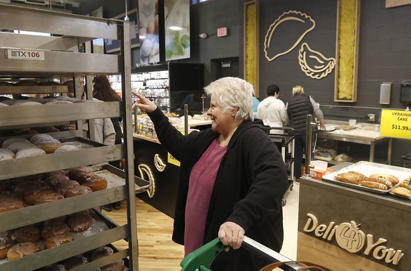 Judy Cleary of Lake in the Hills points out a paczki to her husband, John, as they shop Wednesday, Feb, 15, 2023, for paczki at Deli 4 You, 1501 S. Randall Road in Algonquin. Area bakeries are prepping for the lead-up to Lent when paczki are traditionally eaten. Deli 4 You will make and sell around 30,000 paczki this week.