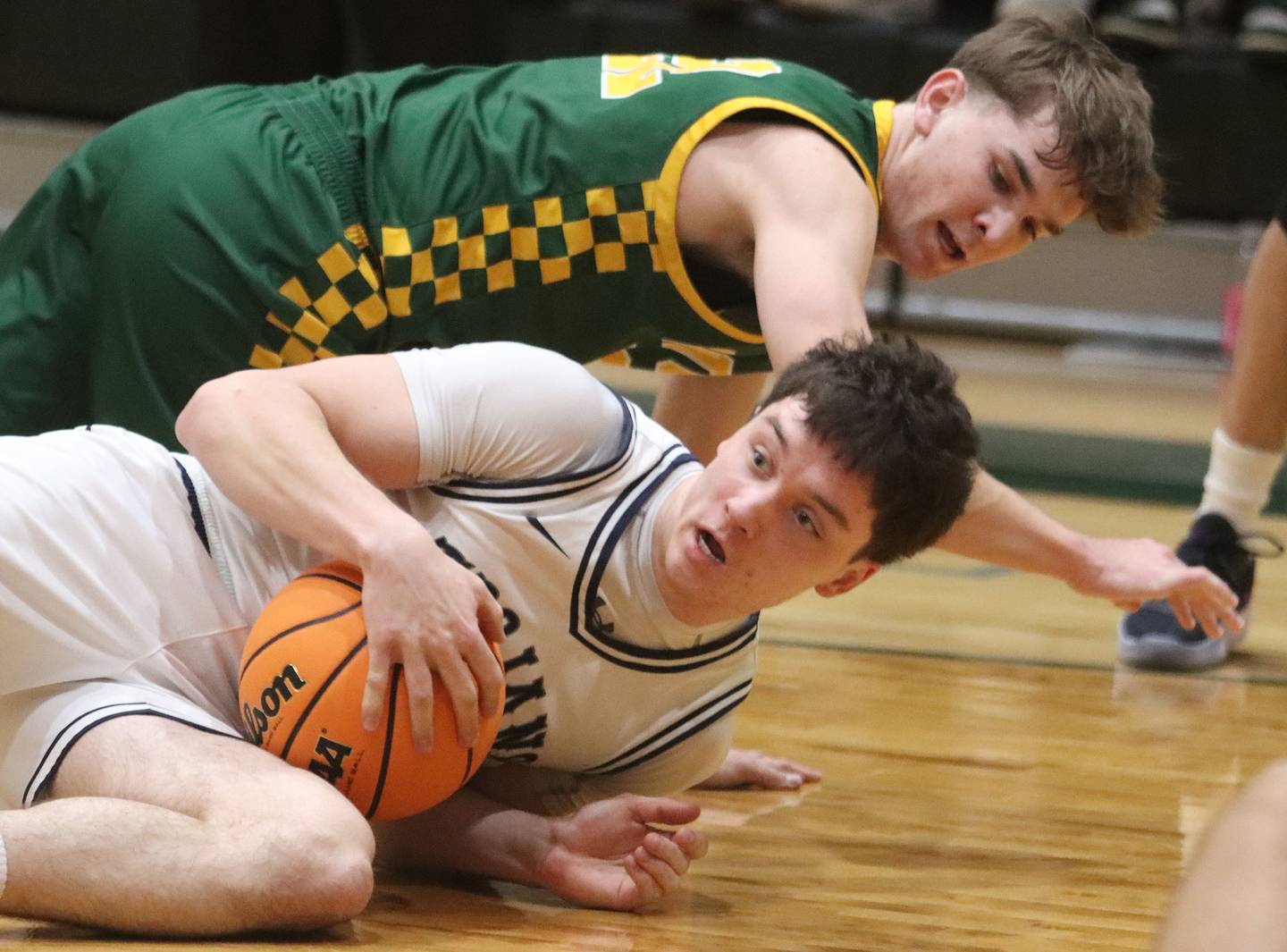 Crystal Lake South’s Nick Stowasser, top, tussles with Cary-Grove’s Brady Bauer for the ball in boys IHSA Class 3A Regional Championship basketball on Friday, Feb. 27, 2026, at Crystal Lake South High School in Crystal Lake.