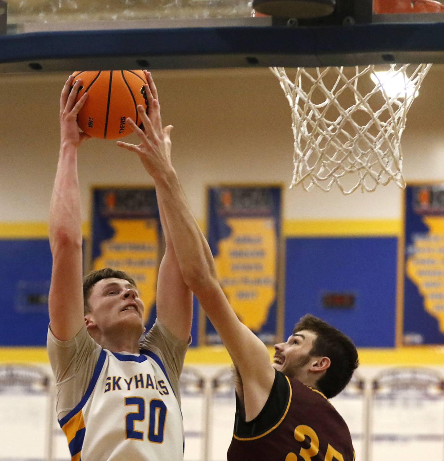 Johnsburg's Josh Kaunas battles for a rebound with Richmond-Burton's Jace Nelson during the IHSA Class 2A Johnsburg Regional Championship boys basketball game on Friday, February, 27, 2026, at Johnsburg High School.