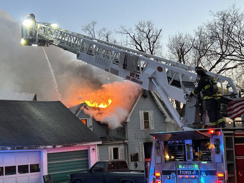 Firefighters from Sterling use their ladder truck to fight a fire at 5500 Mill St. in Emerson on Sunday, Jan. 19, 2025. Fire crews battle the fire in frigid temperatures for several hours.