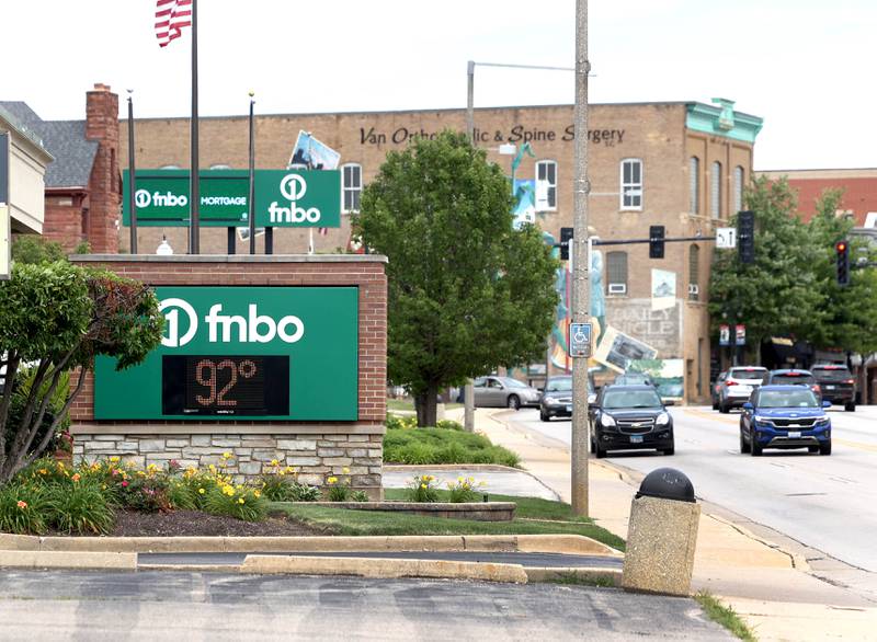 The thermometer reads 92 degrees as traffic drives by Tuesday, June 24, 2025, at the FNBO on Lincoln Highway in DeKalb.