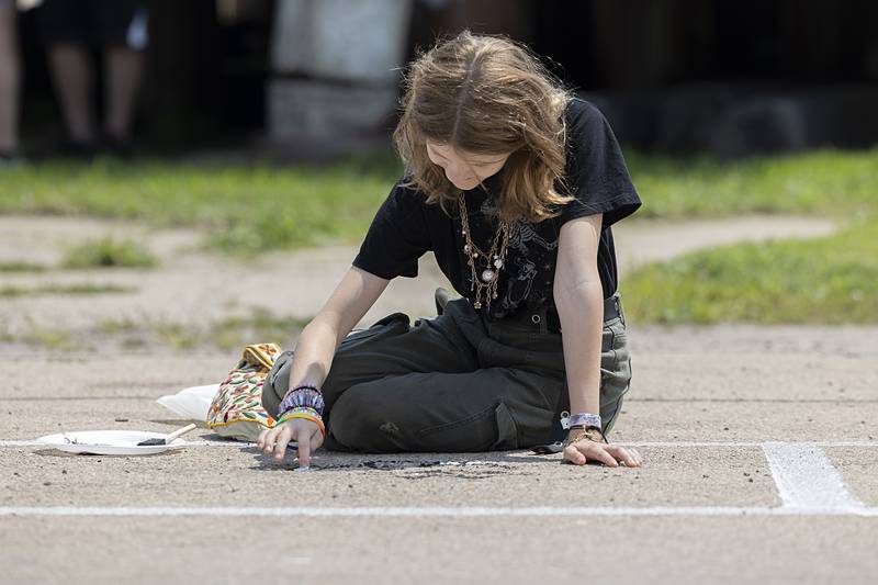 Emma Collinson, 13, paints a picture of a cat Sunday, July 21, 2024 during Tampico Days. Sunday marked the final day of the festival but was still packed with lots of fun activities.
