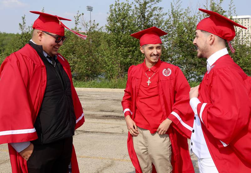 Yorkville High School seniors Misael Perez, Yahir DeLeon and Yael Diaz chat before their commencement ceremony in DeKalb on Friday, May 19, 2023.