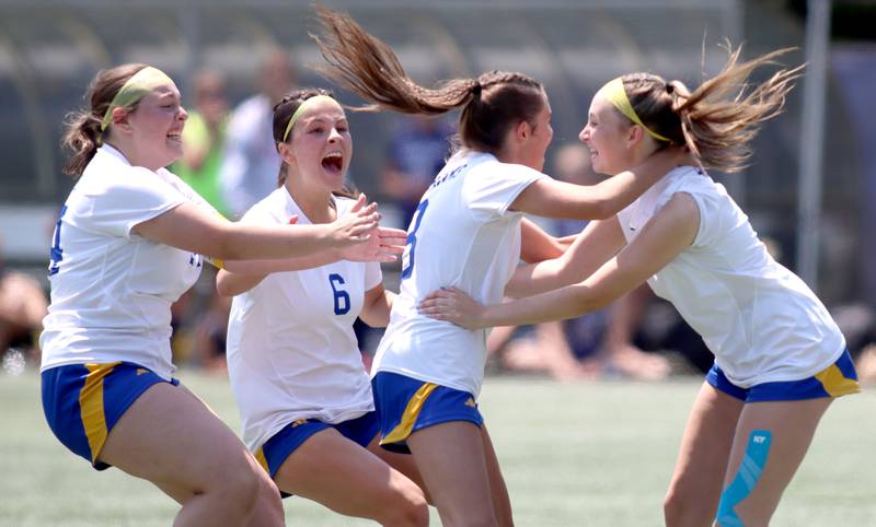 Johnsburg’s Skyhawks celebrate after a Charlie Eastland penalty kick clinched a win over Willows Academy in IHSA Class 1A Supersectional soccer action at Dominican University in River Forest on Saturday, May 31, 2025. From left are Kayla Hiller, Liz Smith, Eastland and Devynn Michel