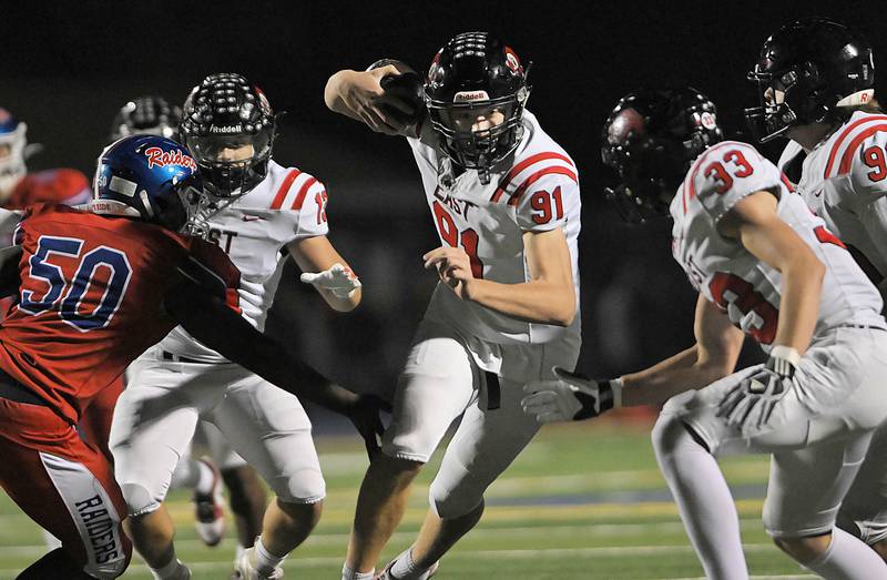 Glenbard East’s Sam Walton cuts back after intercepting a Glenbard South pass and returning it for a touchdown in a football game at South High School in Glen Ellyn on Friday, Oct. 18, 2024.