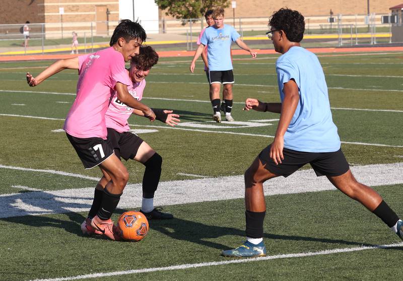 DeKalb’s Julian Godinez (left) works to get by a DeKalb player Monday, July 14, 2025, during a summer boys soccer friendly at DeKalb High School.