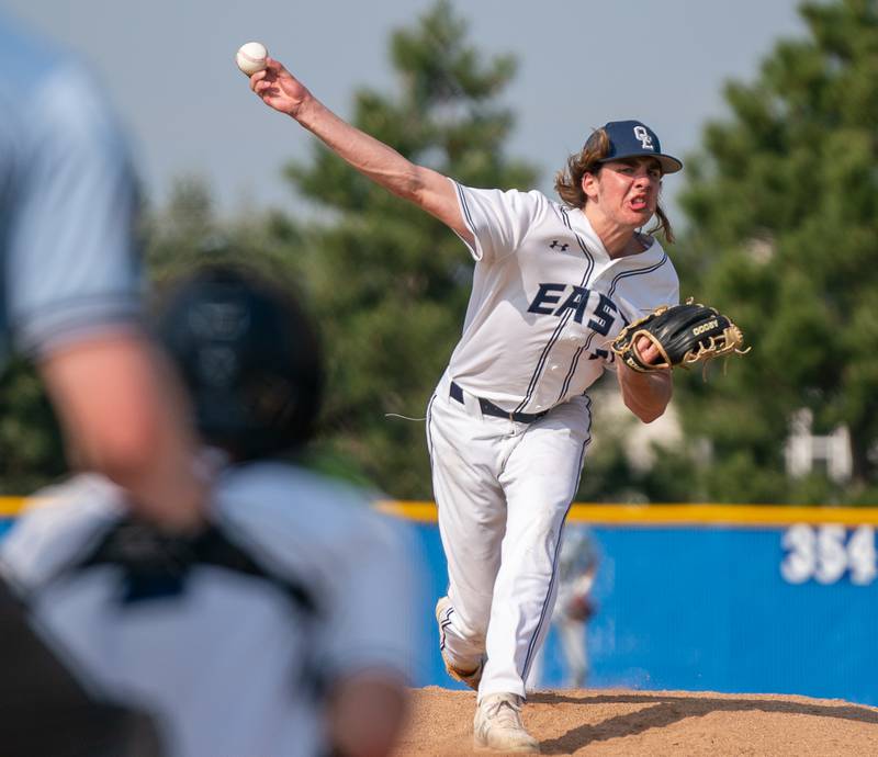 Oswego East's Griffin Sleyko (21) delivers a pitch against Oswego during a baseball game at Oswego East High School on Tuesday, May 10, 2022.