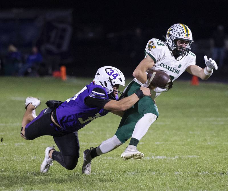 Coal City’s Gavin Berger is pulled down by Dixon’s Owen Belzer after a catch Friday, Nov. 7, 2025.