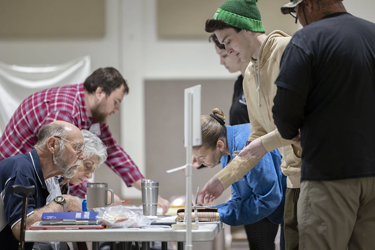 Members of the Brumbly family Toni, Angie, Dylan and Tris check in at their precinct to vote Tuesday, Nov. 8, 2022.
