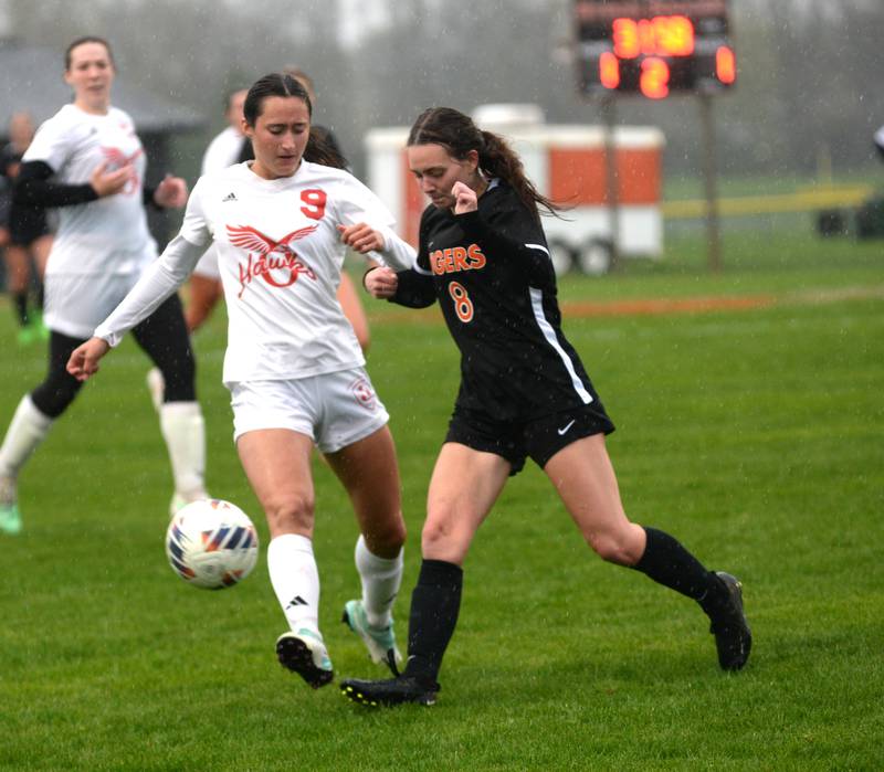 Oregon's Kenna Wubbena (9) and Byron's Ella Hanes (8) battle for the ball on Thursday, April 18, 2024 at Byron High School. The Tigers won the game 2-1.