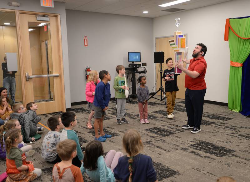 Children help Jason Kollum demonstrate how to balance and juggle during the See a Juggler, Be a Juggler held at the Glen Ellyn Library Saturday April 5, 2025.