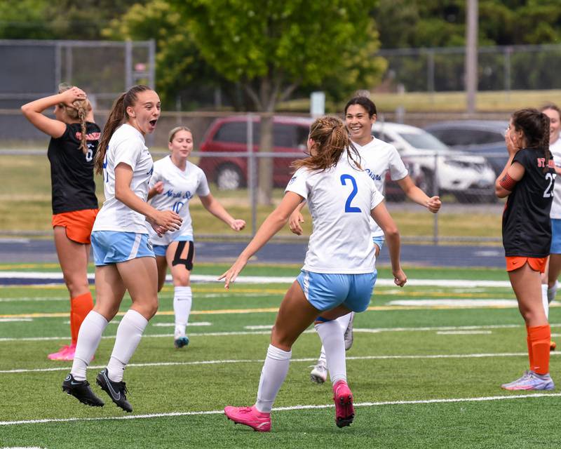 St. Charles North Laney Stark (19) gets congratulated by teammates to tie the game at 1 a piece with 6.9 seconds left in the game while taking on St. Charles East during the sectional title game on May 27th held at West Chicago Community High School.