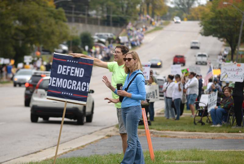 People including Eric and Jenny Brown of Lisle participate in the No Kings Day Rally in Lisle Saturday Oct 18, 2025. This group meets along Ogden and Naperville Rd every Saturday.
