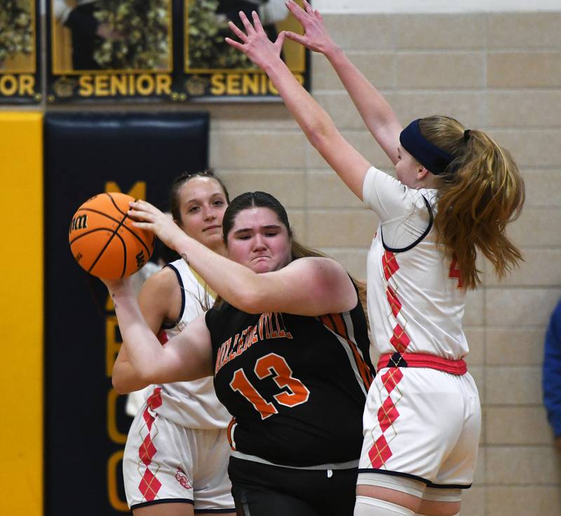 Milledgeville's Olivia Wooden (13) tries to pass the ball out a trap set by Polo's Laynie Mandrell and Camrynn Jones on Saturday, Jan. 24, 2026 at Polo High School.