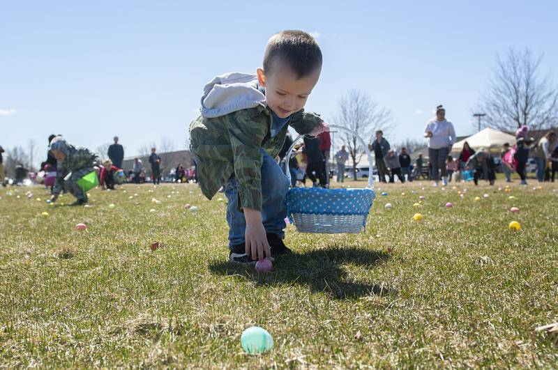 Gabriel Dennis, 3, of Sterling grabs an egg during the Sterling park district Easter egg hunt Saturday, April 9, 2022. The event, held at Westwood, saw hundreds of kids race around a course picking up eggs hiding treats and tickets to win bikes.