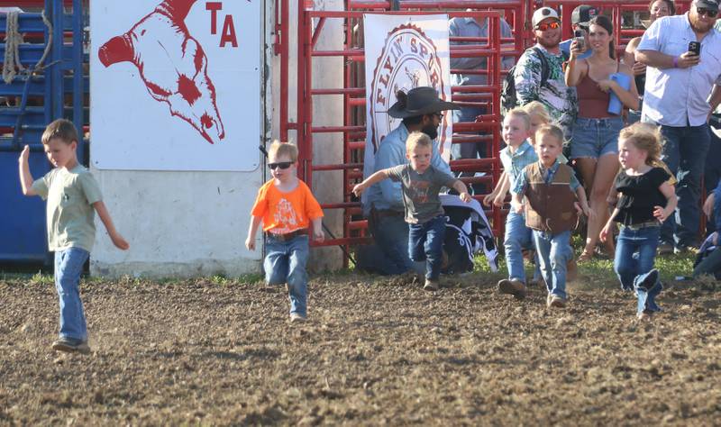 Mutton Busting kids race onto the area during the Starved Rock Rodeo on Saturday, June 21, 2025 at the La Salle Speedway.