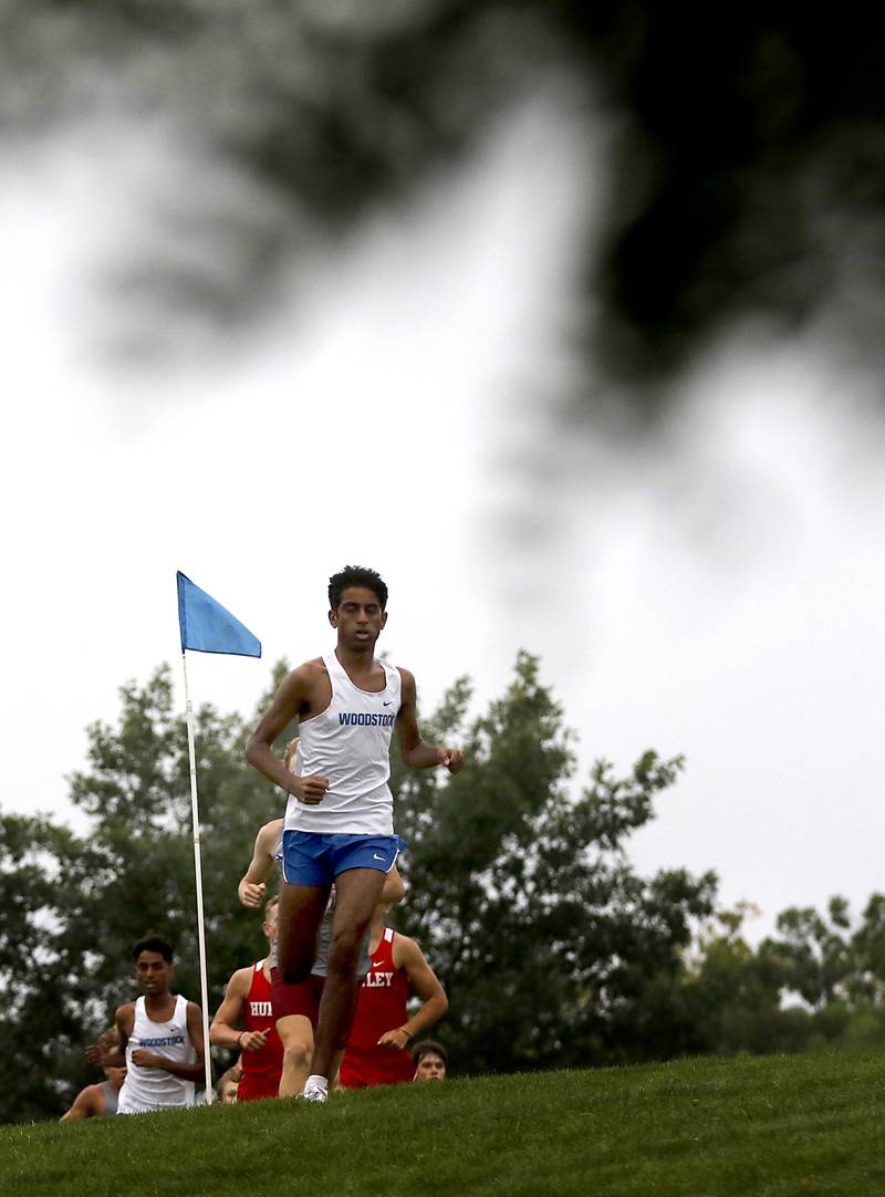 Woodstock’s Ishan Patel leads the boys race of the McHenry County Cross Country Meet Saturday, August 27, 2022, at Emricson Park in Woodstock.