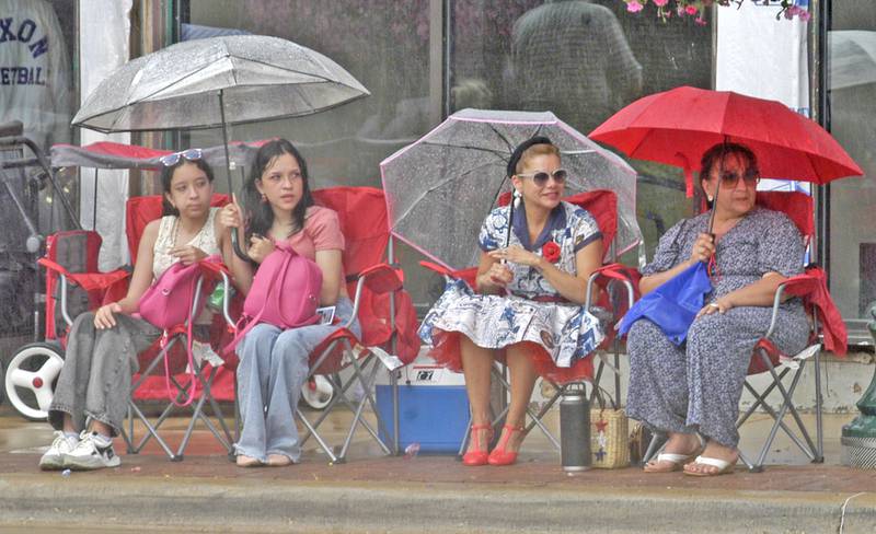 Umbrellas were put to good use once the rains began to fall Sunday, July 6, during the annual Petunia Fest parade.
