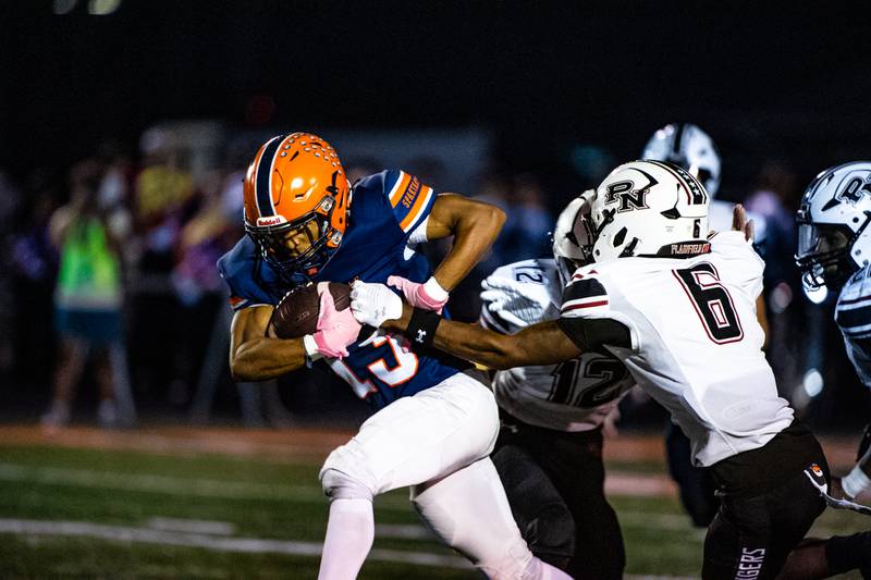 Romeoville's Xavier Santiago pushes past the Plainfield North Defense during a game on Friday Sept. 19, 2025 at Romeoville High School