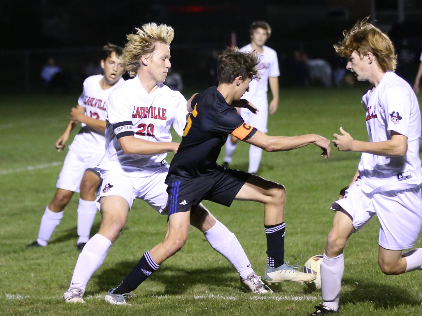 Somonauk's Luke Rader cuts between Earlville's Griffin Cook and Jeff Peterson in the Little Ten Conference championship game on Thursday, Oct. 5,  2023 at Hinckley High School.