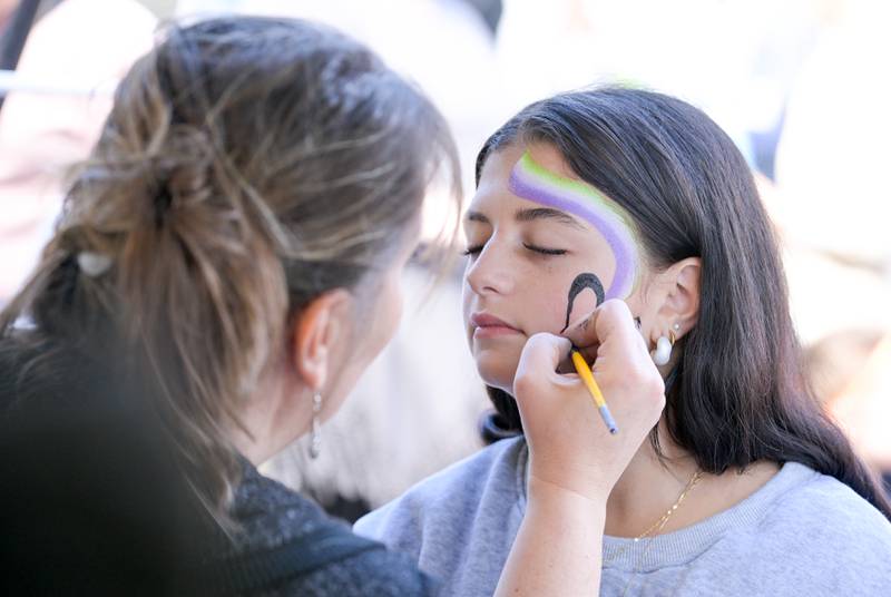 Tabbi Bollendorf of Aurora has her face painted by Bea Vanderveen of the Midwest Fun Factory during the annual Scarecrow Festival on Saturday, Oct 11, 2025 in St. Charles.